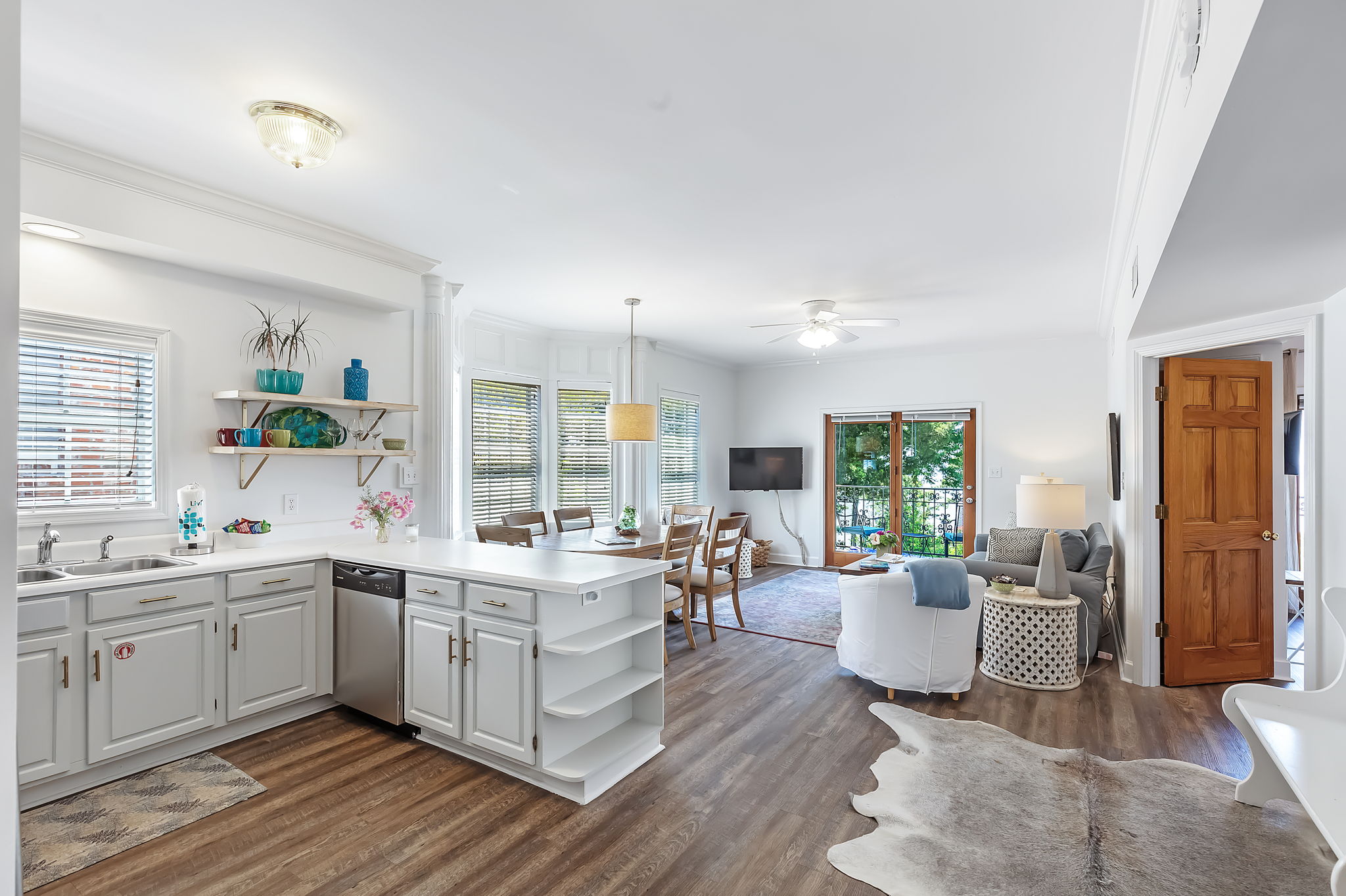 View of bright white kitchen and living area in Camellia Suite