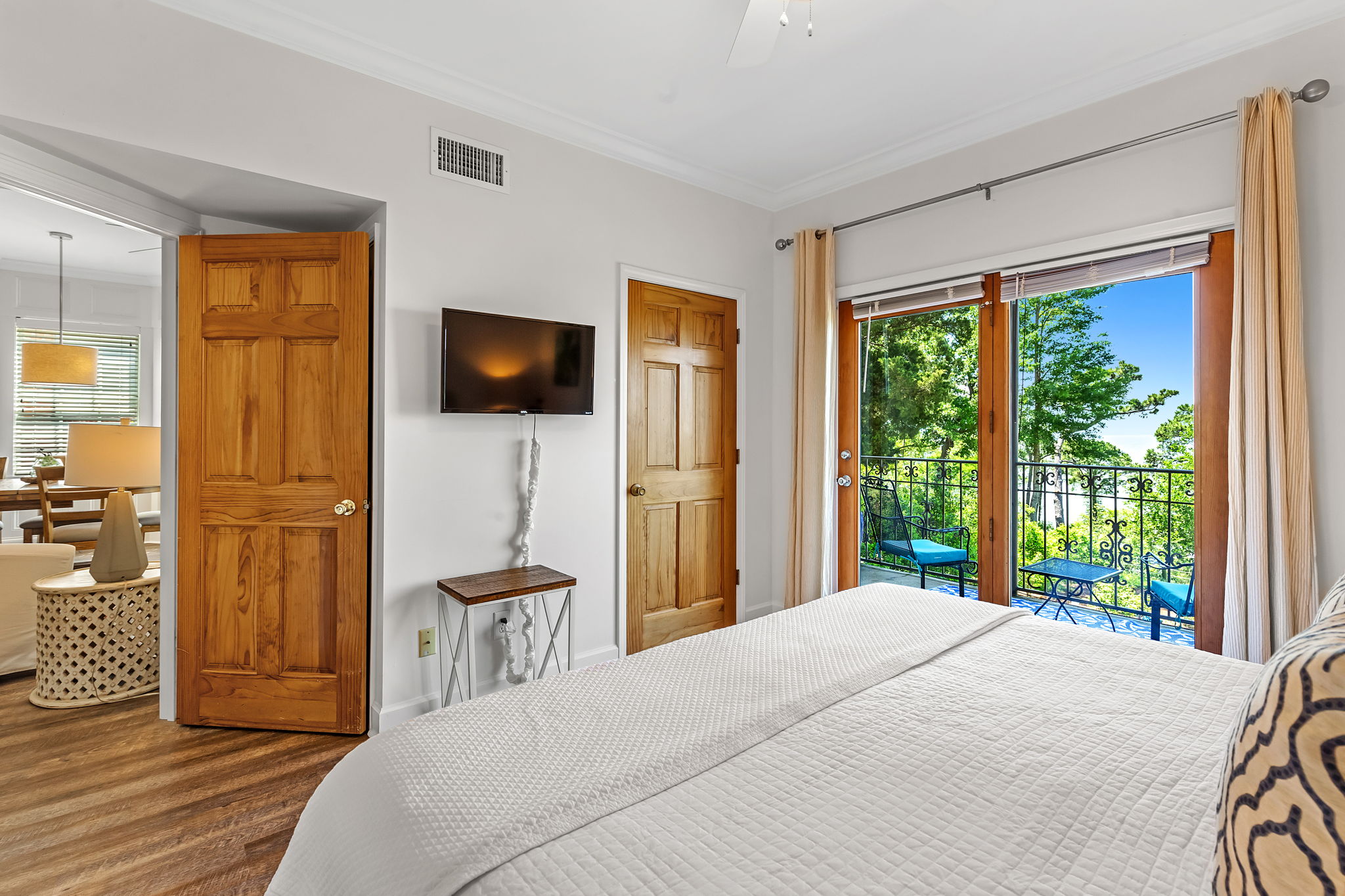 Bay View Bedroom with king bed, doorway leading to main living area and sliding glass doors leading to balcony with bay views