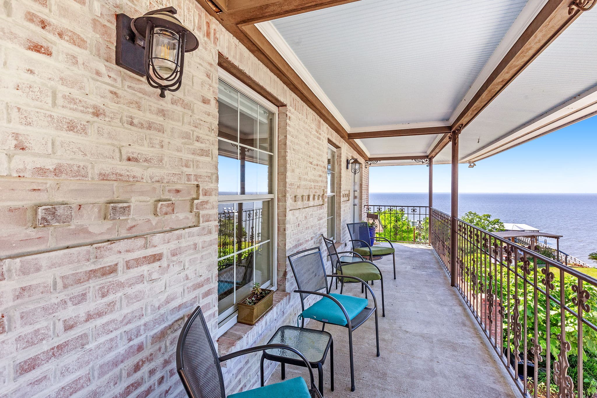 A breathtaking bay view from private patio with comfortable seating.