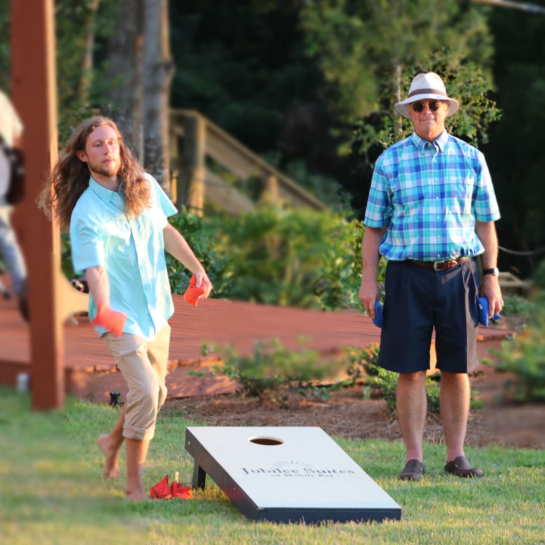 Two men playing cornhole