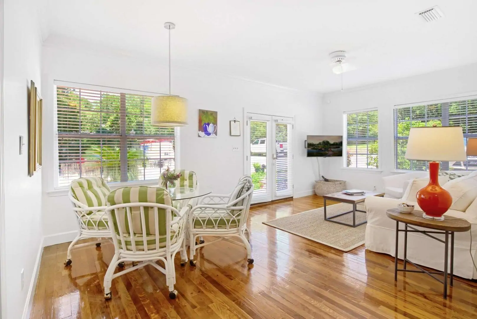 Bright and airy living area with a dining table, comfortable seating, and large windows. Bright and airy living area with a dining table, comfortable seating, and large windows.