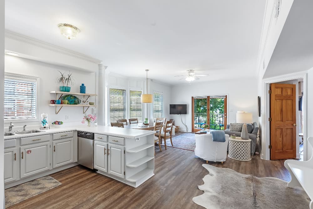 Open-concept kitchen and living area featuring modern decor and ample natural light.