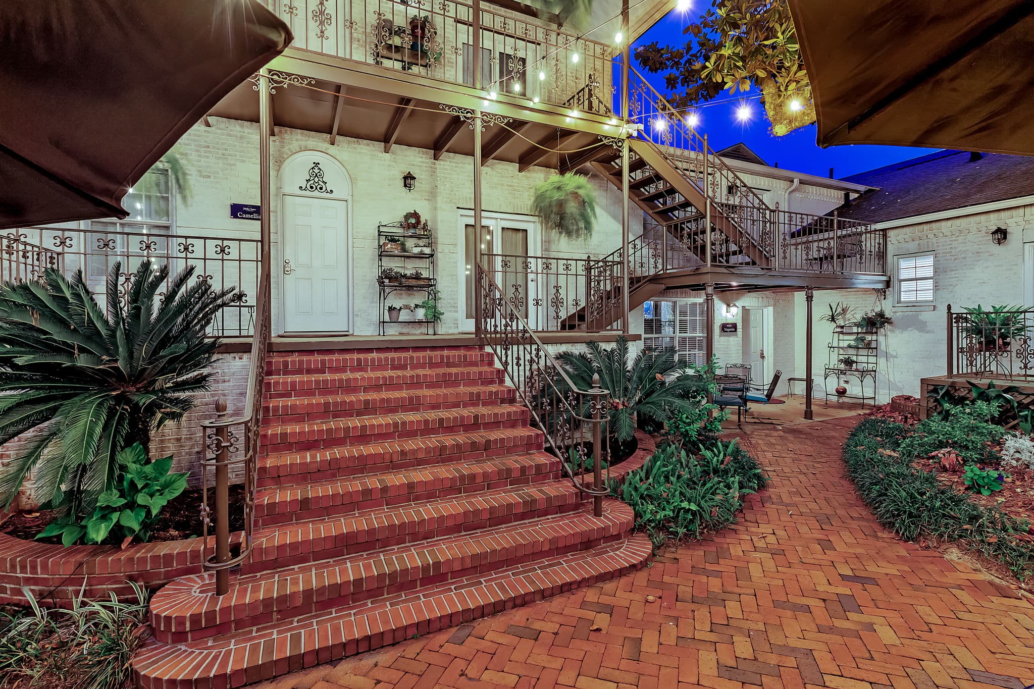 Brick courtyard with lovely landscaping and steps leading to Jubilee Suites