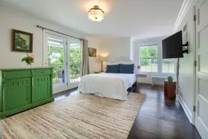 Queen bedroom and balcony doors in Satsuma Suite at Jubilee Suites in Fairhope, AL